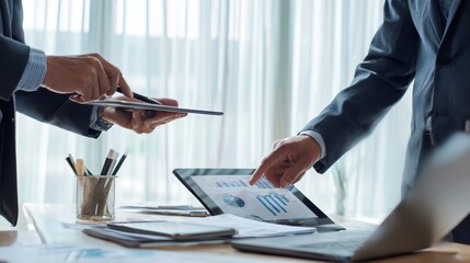 The professionals collaborating over data analysis in a modern office setting.