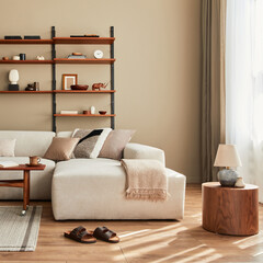 Modern interior of living room with design modular beige sofa, coffee table,  furniture, pendant lamp, shelf, slippers, carpet, decoration and elegant personal accessories in home decor. Template.