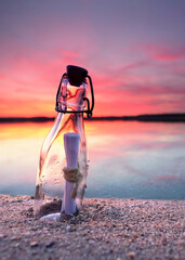a message in a bottle on the beach with an amazing sunset