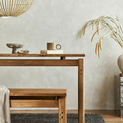 Elegant dining room interior composition with wooden dining table, bench and design home decorations and personal accessories. Modern home staging. Wabi sabi inspiration. Template.