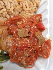 Spicy chicken liver sambal with sliced red chilies and onions in a rich red sauce, served alongside...