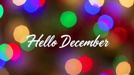 Hello December text inscription over blurred multicolored Christmas tree lights festive bokeh background.Winter holidays, New Year greeting card,4K video.