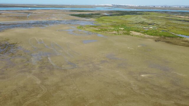 Ria Formosa with riverbed exposed at low tide in Algarve, Portugal