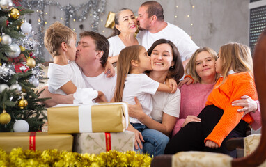 Family with children on sofa in christmas interior