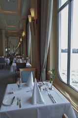 Formal and elegant ocean view dining room restaurant onboard luxury cruiseship or cruise ship liner...