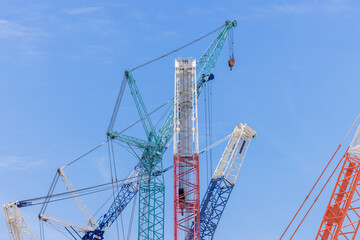 Crawler crane on blue sky white clouds background, Real estate industry. Red crawler crane use reel lift up equipment in construction site. Crane for rent. Crane dealership for construction business.