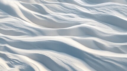 Obraz premium Close-up of smooth, undulating snow drifts, creating a serene and tranquil winter landscape.