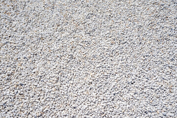 Architectural background. Small white gravel stones for landscape design. Urban garden detail. Uniform decorative pebbles for park or yard paths