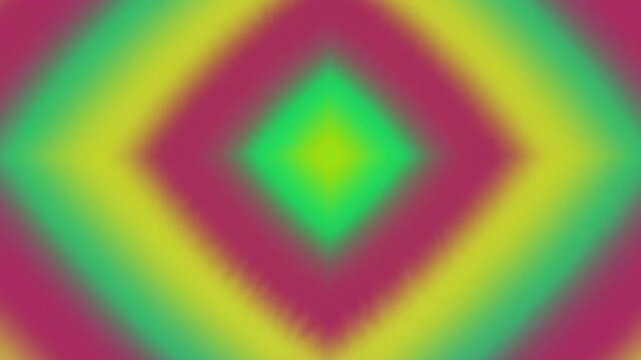 A blurry, diamond-shaped pattern of green, yellow, and pink colors fills the frame.