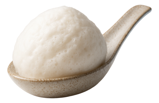 A light, airy scoop of coconut foam sitting on a textured ceramic spoon.
