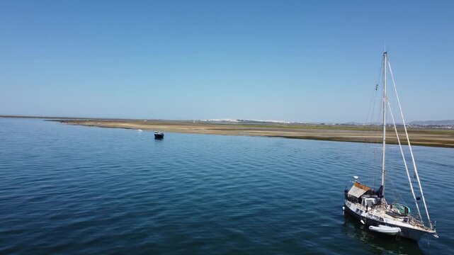 Ria Formosa riverbed with Fundo do Albufeira with yachts anchored in the river in Algarve, Portugal