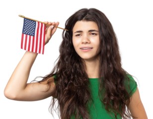 A young happy girl with a smile on her face holds an American flag in her hands. Symbol of patriotism and freedom.