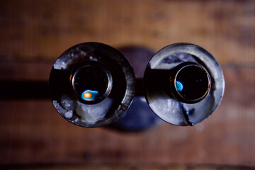 Lit and unlit candles in a candelabra against a dark background, evoking warmth and memory.