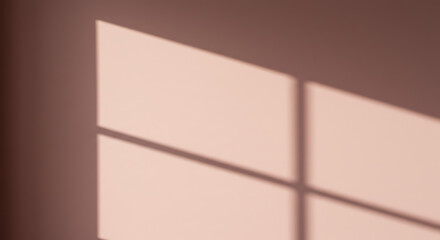 Sunlight casts geometric shadows on a wall creating an abstract pattern