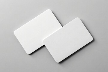 Two blank white rounded corner cards on gray surface