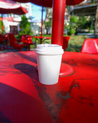 plain paper cups coffee mockup on the red table outdoor scene