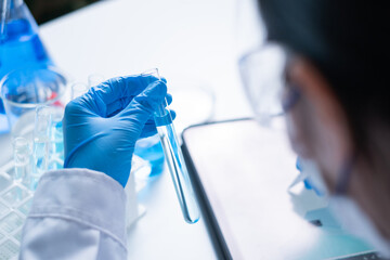 Professional Asian woman scientist chemist technician experiment research in chemistry laboratory data analysis result report scientific innovation document