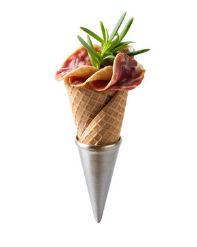 Naklejki Photo of creative presentation of sliced salami and fresh rosemary sprigs arranged in a waffle cone, suggesting an unusual and savory snack or appetizer, isolated on transparent background