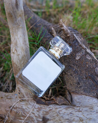 Perfume bottle mockup with plain white label on the wood nature background