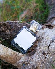 Perfume bottle mockup with plain white label on the wood nature background