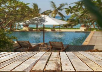 Wooden table top on the beach or sea. swimming pool Party on the beach  sunshine time concept.For montage product display or design key visual layout.View of copy space.