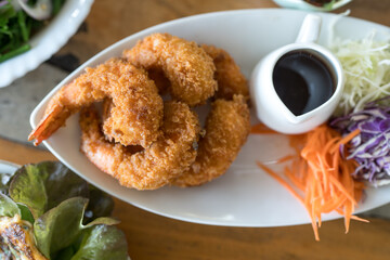 Crispy deep fried shrimps with sweet sauce and slice of many vegetable