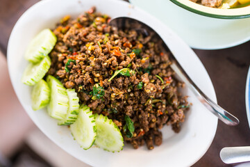 Thai style stir fried minced beef and holy basil served with sliced ​​cucumber