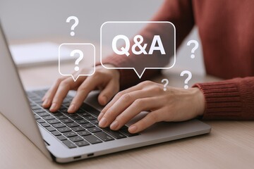 Typing Questions and Answers on Laptop: Online Support and Information Concept