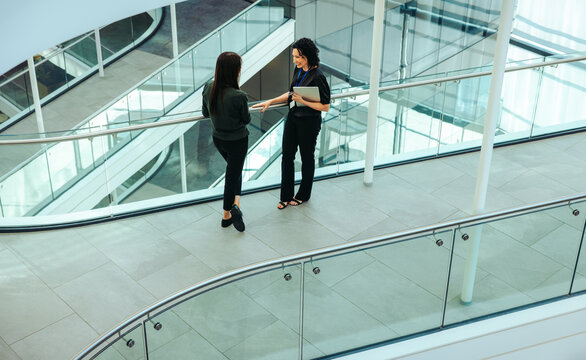 Corporate professionals discussing strategies on a modern flyover