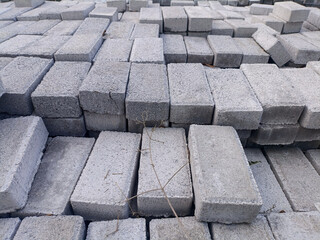 High-quality stack of durable concrete paving blocks in an outdoor storage yard, ready for shipment...