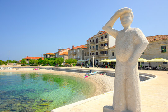 Brac, Croatia - June 12, 2025: Statue of a man watching the sea. Rot beach in Postira. Brac island, Croatia