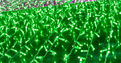 background of holiday colorful green garland for texture and design, festive decoration close up