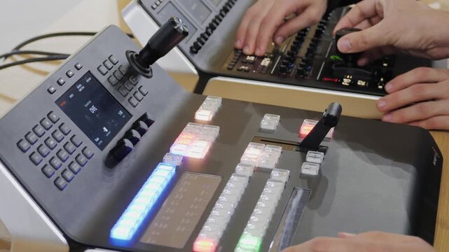 Direct production stage, Telecine controller machine and man hand editing or adjusting color on digital video movie or film in the post production stage. 