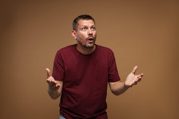 Man suffering from panic attack on brown background