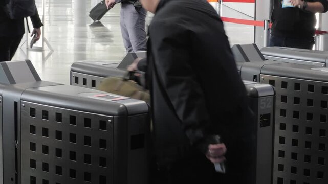 Businessman hand with business wear using smartphone to open automatic gate machine in office building. Working routine concept