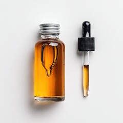 Amber liquid in a clear glass bottle with a silver cap and a separate glass dropper, set against a white background