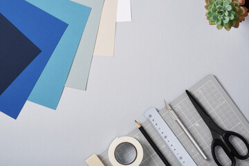 Gray cutting mat and other tools for paper crafts. Top view of the desktop, space for your text.