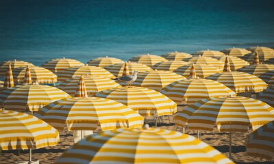 Fototapeta premium Beach umbrellas, yellow and white stripes, seagull