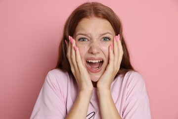Teenage girl suffering from panic attack on pink background