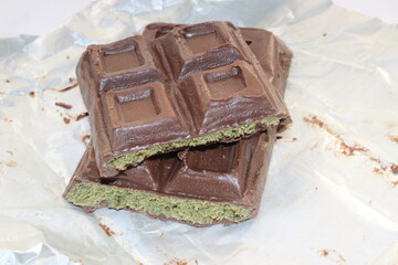 Chocolate with pistachio isolated on white background. Close-up.