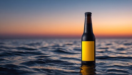 Dark beer bottle on rippled water at sunset