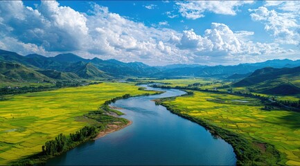 An aerial view of a meandering river flowing through a verdant valley, surrounded by rolling hills under a bright, partly cloudy sky
