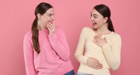 Beautiful women laughing on pink background. Positive emotion