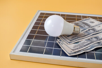 Composition with solar panel, led lamp, money  on texture background.