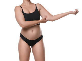 Liposuction. Woman in underwear touching her arm on white background, closeup