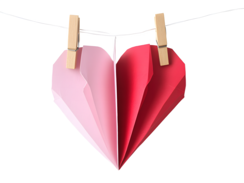 Two halves of a paper heart one pink and one red hang on a string with clothespins isolated on transparent background