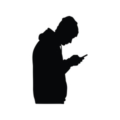 Silhouette of person in hoodie looking down at smartphone, addiction, technology, digital device usage
