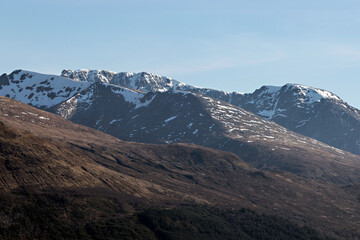 The Nevis Range mountains on a clear day. Aonach Mor slopes in the foreground, then Carm Mor Dearg with the summit of Ben Nevis behind. Lochaber, Scotland.