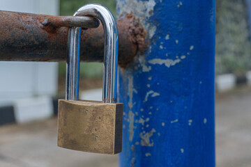 Locks Closure Rustic Gate with Metallic Shine in Soft Focus.