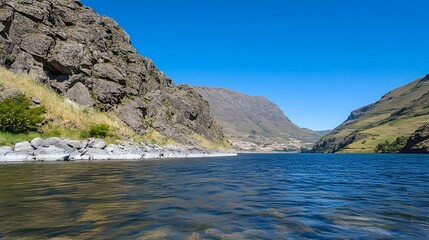 Stunning Mountain Lake Landscape with Rugged Cliffs and Distant Village